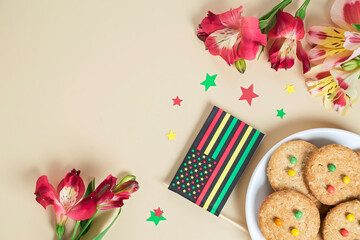 creative background for Juneteenth day with Black Liberation African American flags, tea cakes cookie and bright flowers