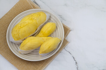 Top view Fresh durian in packaging on plate Famous tropical fruit. Durian king of Thailand fruit.