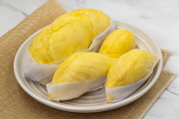 Fresh durian in packaging on plate Durian king of Thailand fruit. Famous tropical fruit.
