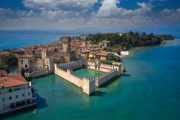 Fototapeta na wymiar Town of Sirmione entrance walls view, Lago di Garda, Lombardy region of Italy drone view. Aerial view of Sirmione, an ancient village on southern Garda Lake. Italian castles Scaligero on the water.