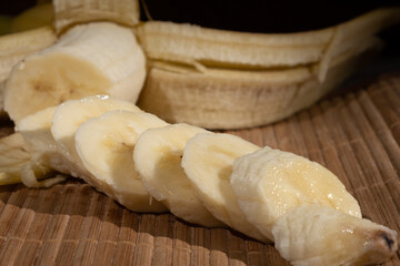 Bananas cut into pieces on a wooden table
