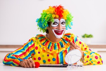 Male clown preparing for perfomance at home