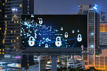 Padlock icon hologram on road billboard over panorama city view of Bangkok at night to protect...