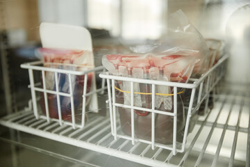 Close up of blood bags supply in medical fridge at clinic, copy space