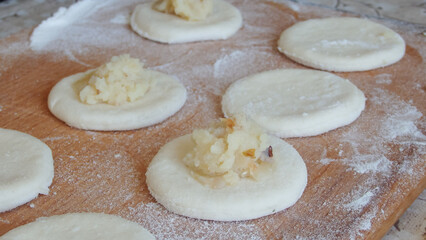 Cooking dumplings stuffed with yeast dough. Making traditional dumplings
