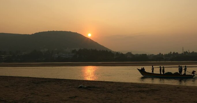 Motor Boat Floating On The River At Sunset