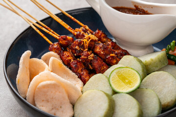 Sate Kacang or Chicken satay is Indonesian traditional Food skewered with grilled meat and rice cake , served with peanut sauce