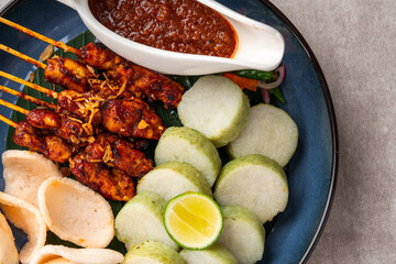 Sate Kacang or Chicken satay is Indonesian traditional Food skewered with grilled meat and rice cake , served with peanut sauce