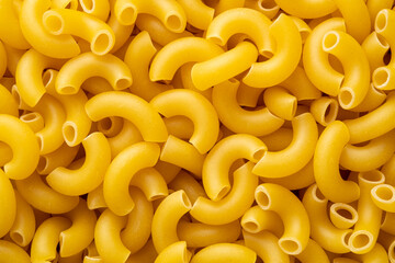 Close up uncooked elbow macaroni for background.Top view