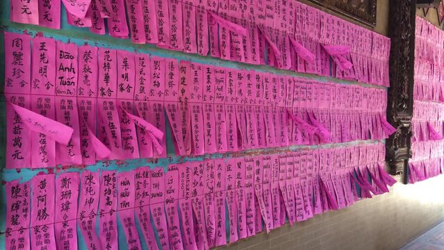 wind blows purple papers with the names of benefactors who donated certain amounts for the benefit of the Thien Hau Temple at Cho Lon. Ancient asian culture