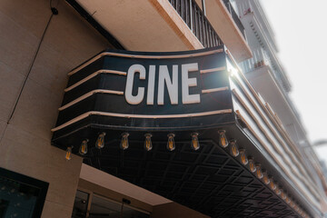 Outdoor billboard on the street with the word Cinema, backlit.