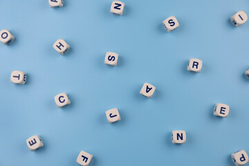  cubes or blocks word with letters randomly on a blue background - the concept of a newborn boy,...