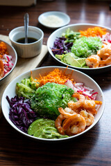 Shrimp Poke Bowl with Seaweed, Avocado, Cucumber, Radish, Cabbage, Sesame Seeds and Teriyaki Sauce
