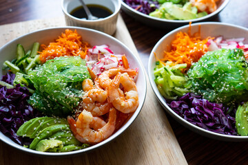 Shrimp Poke Bowl with Seaweed, Avocado, Cucumber, Radish, Cabbage, Sesame Seeds and Teriyaki Sauce