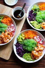 Shrimp Poke Bowl with Seaweed, Avocado, Cucumber, Radish, Cabbage, Sesame Seeds and Teriyaki Sauce