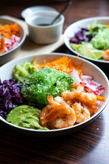 Shrimp Poke Bowl with Seaweed, Avocado, Cucumber, Radish, Cabbage, Sesame Seeds and Teriyaki Sauce