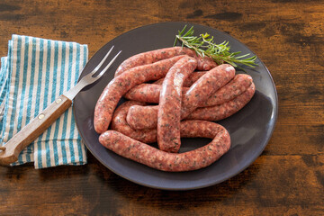 raw herb sausages on a plate