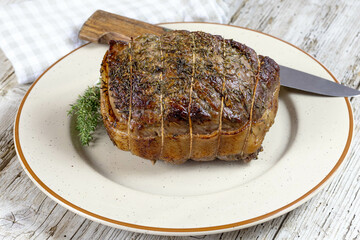 cooked whole roast beef on a plate