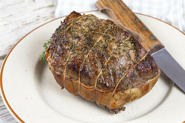 cooked whole roast beef on a plate