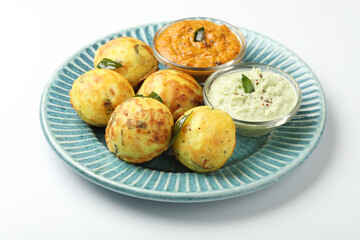 Kuzhi Paniyaram served with coconut chutney and sambar- South Indian breakfast with black lentils and rice