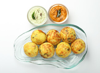 Kuzhi Paniyaram served with coconut chutney and sambar- South Indian breakfast with black lentils and rice