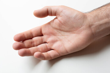 A man's hand is depicted in a close-up palm on a gray background.