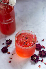 glass of rose Kombucha with iced on white table ,fermented tea drink, healthy beverage.