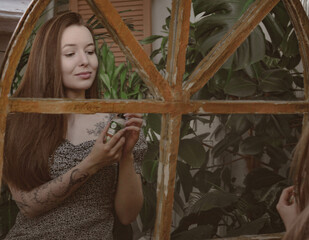 girl with long hair on the background of foliage