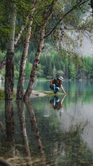 Fototapeta na wymiar Woman on lake in mountains