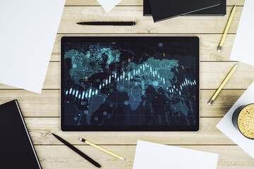 Modern digital tablet display with abstract creative financial chart and world map, research and analytics concept. Top view. 3D Rendering