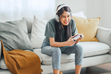 Excited woman playing a computer games with joystick, copy space.