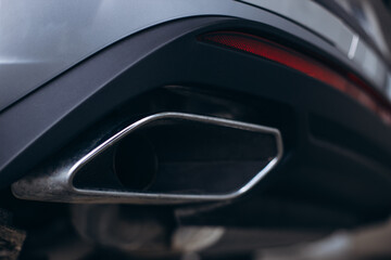Exhaust pipe under car, close up photo