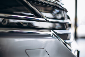 Headlights in a new car in car showroom
