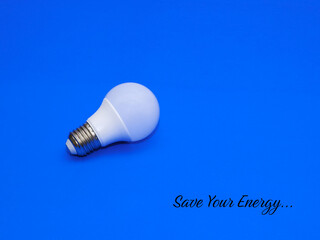 Save Your Energy. Light bulb isolated with blue background.