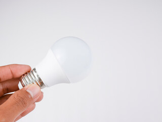A man holds a light bulb.