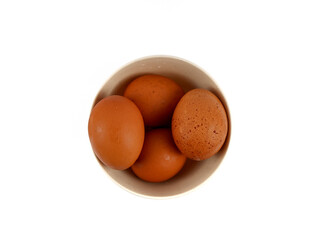 Chicken eggs in a bowl. Isolated with white background.