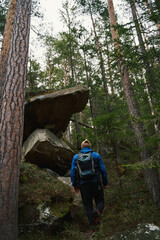 Active male person hiking alone on mountain