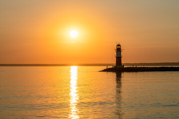 Fototapeta premium Lighthouse Ostmole Warnemünde at sunrise, Rostock, Germany