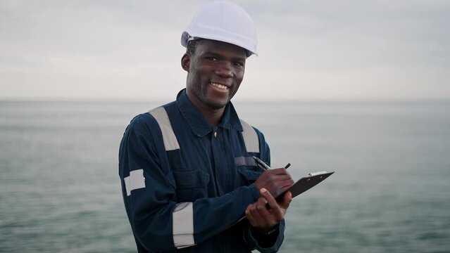 Friendly black seaman making notes