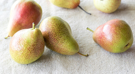 An arrangement of Anjou pears on a rustic woven mat.