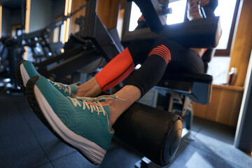 Sportsperson working out on fitness equipment at gym