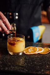 fruit cocktail is prepared by a bartender