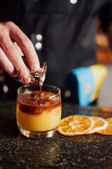 fruit cocktail is prepared by a bartender