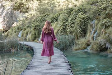 Woman wandering around the Plitvice Lakes National Park from Croatia.