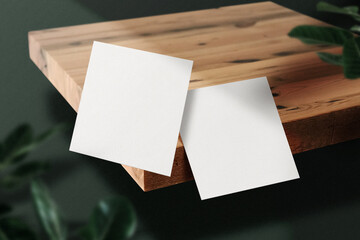 Clean minimal square flyer mockup floating on wooden plate with leaves