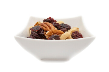 A white bowl with dried fruits and nuts, isolated on white background.Dried fruits are so called...