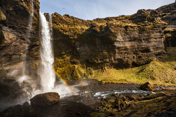 The beautiful Kvernufoss waterfall with a small double rainbow, in the beautiful Kvernugil gorge, near Route 1 / Ring Road, Southern Region, Iceland