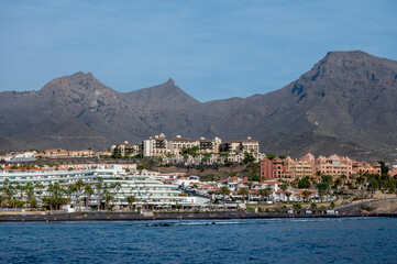 Fototapeta na wymiar View on resorts and beaches of South coast of Tenerife island during sail boat trip along coastline, Canary islands, Spain