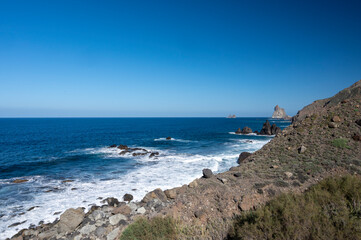 Panoramic view on lava rocks of Playa del Roque de las Bodegas and blue Atlantic ocean, Anaga national park near Tanagana village,  North of Tenerife, Canary islands, Spain