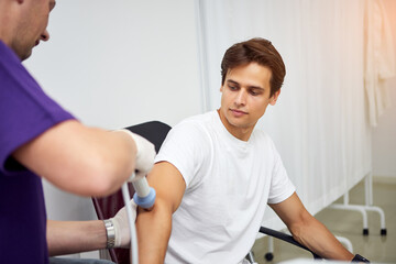 Shock wave therapy. Physiotherapist doctor uses medical equipment for highly effective...